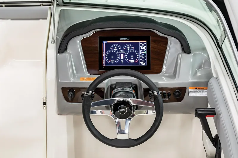Slide: The Image of 2025 Chaparral SSI boat dashboard with steering wheel and digital display. - 14