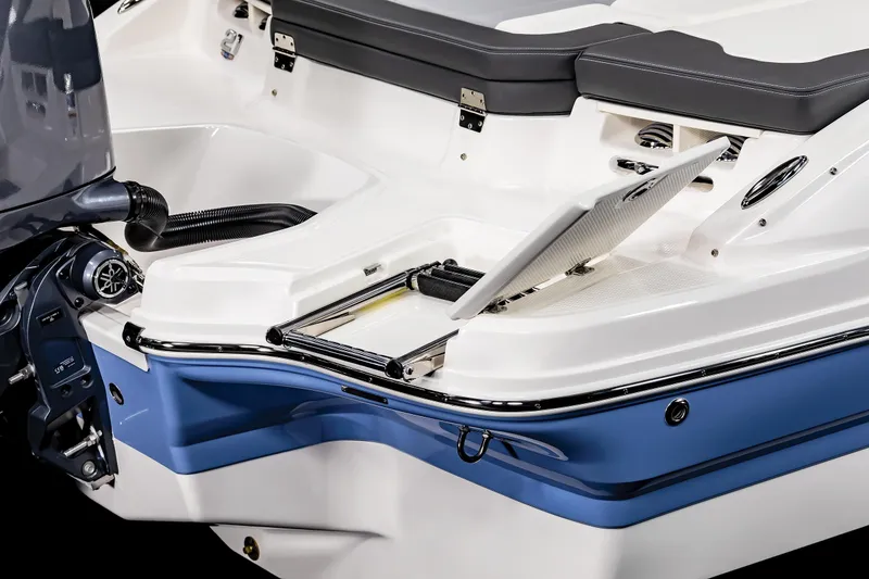 Slide: The Image of 2025 Chaparral SSI boat with sleek blue and white design, featuring a swim platform. - 26