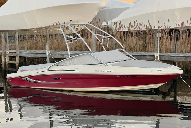 The Image of 2010 Sea Ray 205 Sport boat docked on calm water. - 0