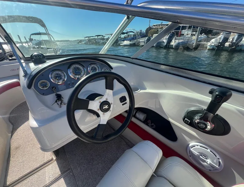 Slide: The Image of 2010 Sea Ray 205 Sport boat interior with steering wheel and control panel. - 10