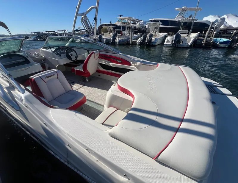 Slide: The Image of 2010 Sea Ray 205 Sport boat with red and white interior, docked at marina. - 3