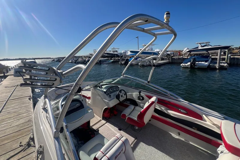 Slide: The Image of 2010 Sea Ray 205 Sport boat docked at marina, sunny day, clear water. - 5