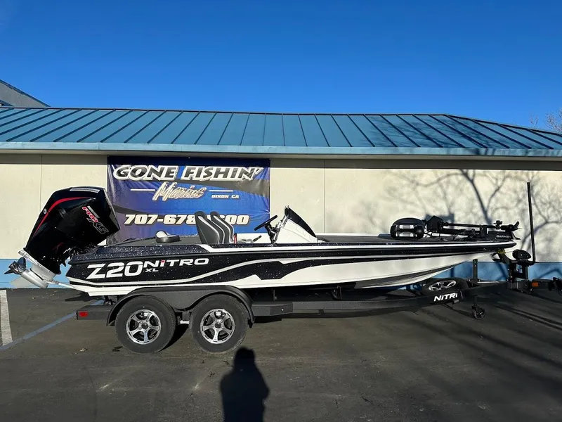 The Image of 2025 Nitro Z20 XL Pro boat on trailer, parked outside a building. - 1