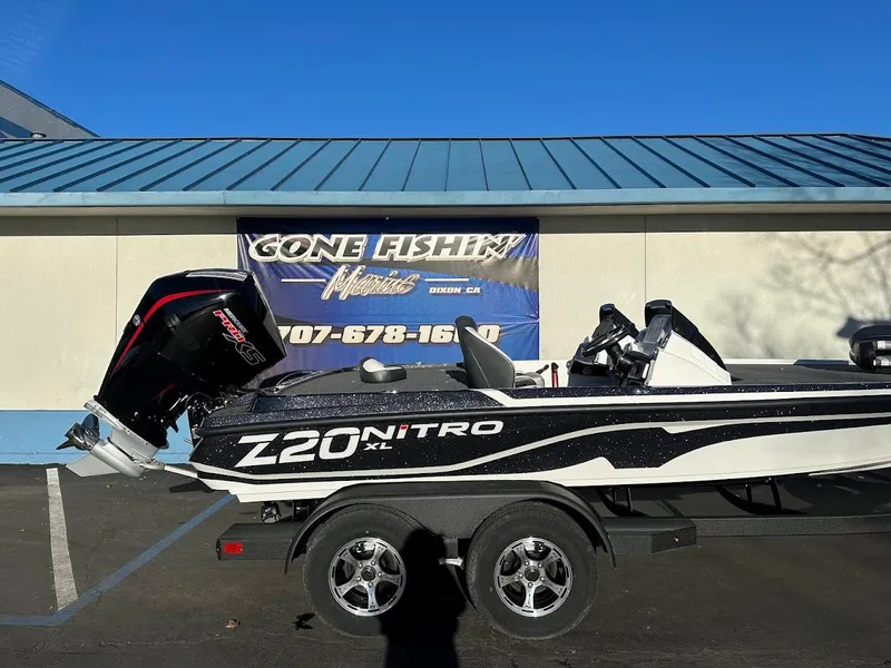 Slide: The Image of 2025 Nitro Z20 XL Pro boat on trailer, parked outside a fishing store. - 6