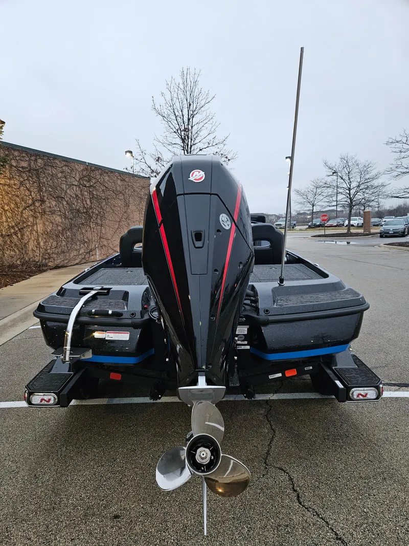 Slide: The Image of 2025 Nitro Z21 XL boat, rear view, parked in a lot. - 3
