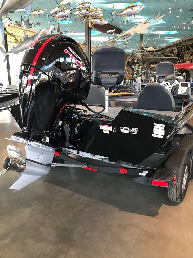 Slide: The Image of 2025 Tracker Pro Team 195 Tournament Edition boat with powerful outboard motor in showroom. - 2