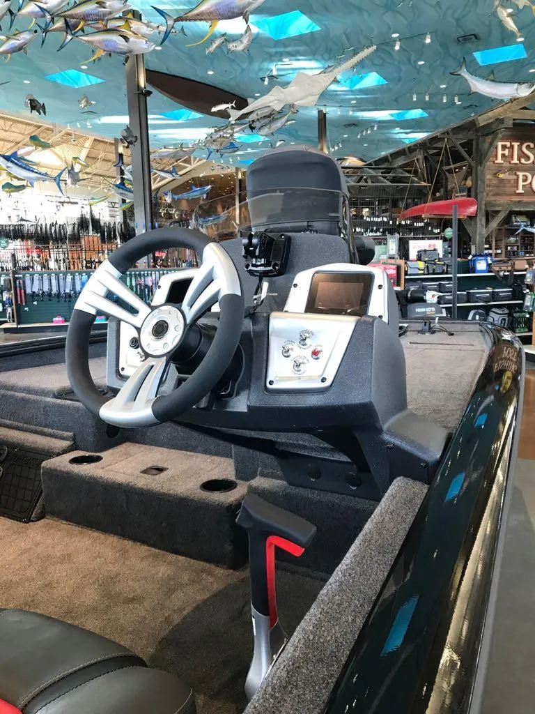 Slide: The Image of 2025 Tracker Pro Team 195 Tournament Edition boat interior with steering wheel and control panel. - 3