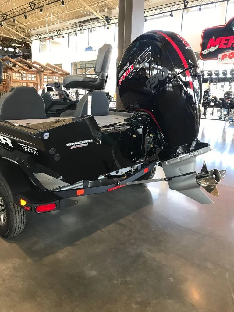 Slide: The Image of 2025 Tracker Pro Team 195 Tournament Edition boat with powerful engine in showroom. - 5