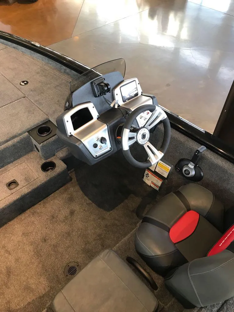 Slide: The Image of 2025 Tracker Pro Team 195 Tournament Edition boat interior with steering console and seating. - 9