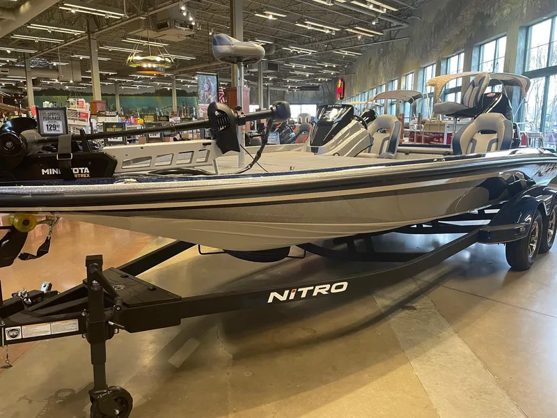 Slide: The Image of 2025 Nitro Z21 XL boat displayed indoors on a trailer. - 3