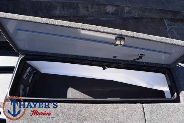 Slide: The Image of Open storage compartment in 2025 Caymas CX 21 PRO boat, Thayer's Marine logo visible. - 14