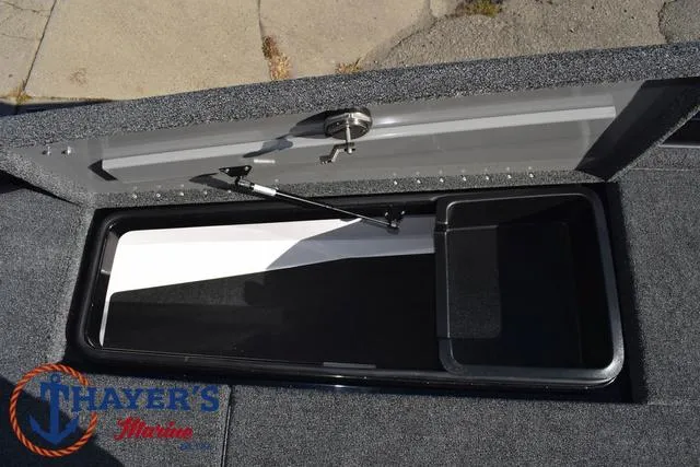 Slide: The Image of 2025 Caymas CX 21 PRO boat storage compartment, open lid, Thayer's Marine logo visible. - 15