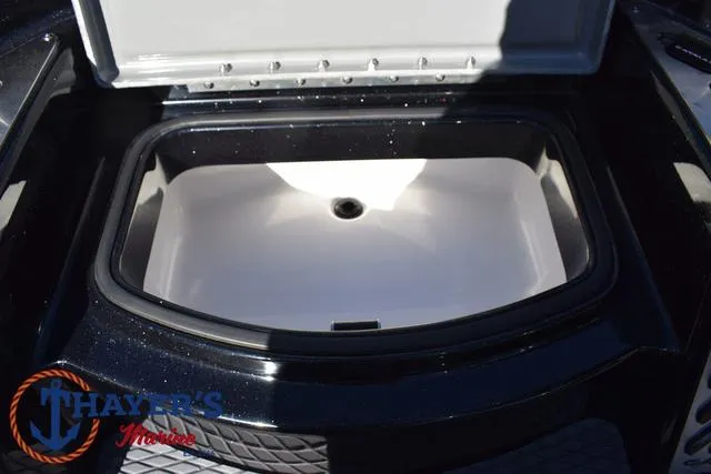 Slide: The Image of 2025 Caymas CX 21 PRO livewell with open lid, featuring spacious interior. - 19