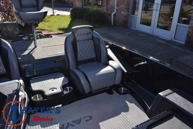 Slide: The Image of 2025 Caymas CX 21 PRO boat interior with cushioned seating and cup holders. - 21