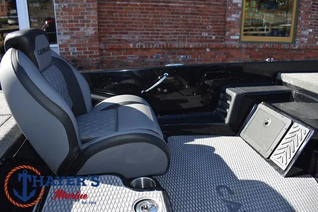 Slide: The Image of 2025 Caymas CX 21 PRO boat interior with gray seating and storage compartments. - 22
