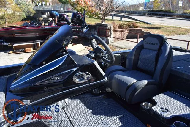 Slide: The Image of 2025 Caymas CX 21 PRO boat interior with steering wheel and seating. - 25