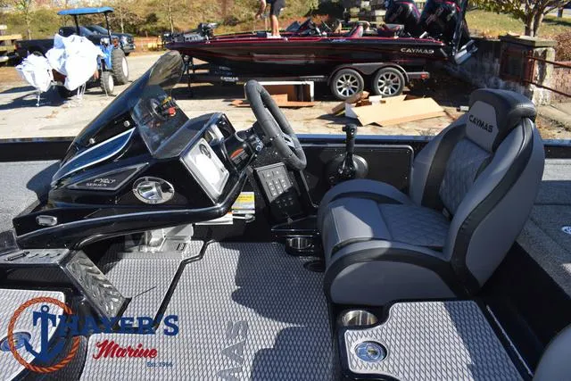 Slide: The Image of 2025 Caymas CX 21 PRO boat interior with steering console and seating. - 26