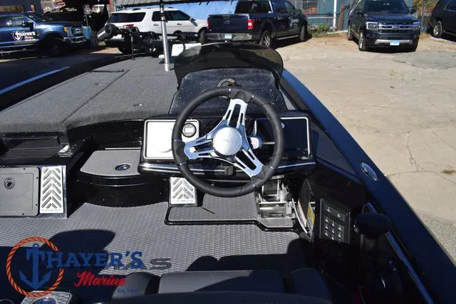 Slide: The Image of 2025 Caymas CX 21 PRO boat interior with steering wheel and dashboard controls. - 27