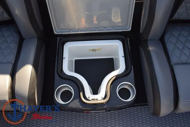 Slide: The Image of 2025 Caymas CX 21 PRO boat interior with cup holders and storage compartment. - 32