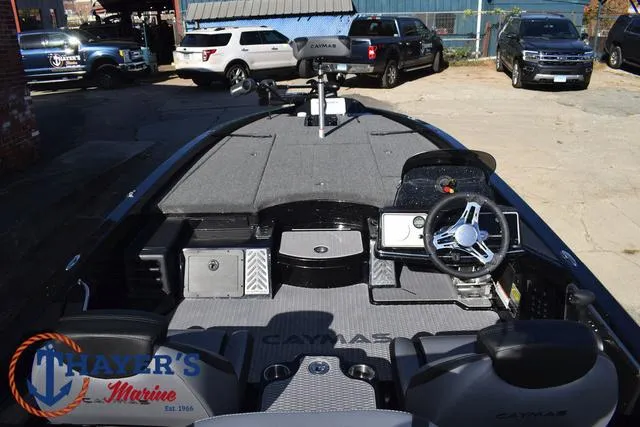 Slide: The Image of 2025 Caymas CX 21 PRO boat interior with steering wheel and dashboard, parked outdoors. - 42