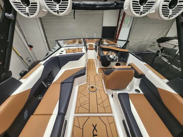 Slide: The Image of 2024 ATX Boats 24 TYPE-S interior with tan and black seating, modern design, and premium audio system. - 5