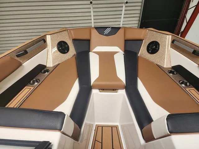 Slide: The Image of 2024 ATX Boats 24 TYPE-S interior with tan and black seating, cup holders, and modern design. - 7