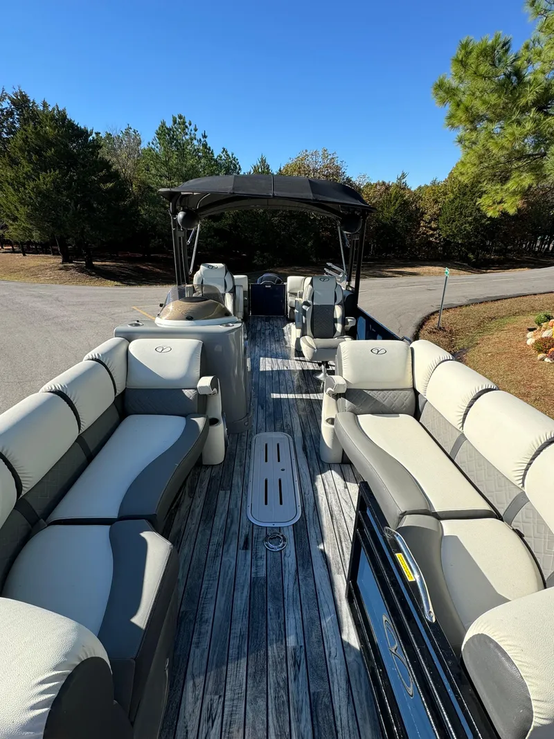 Slide: The Image of 2019 Veranda VP25RCT pontoon boat with spacious seating and canopy, parked on a sunny day. - 5