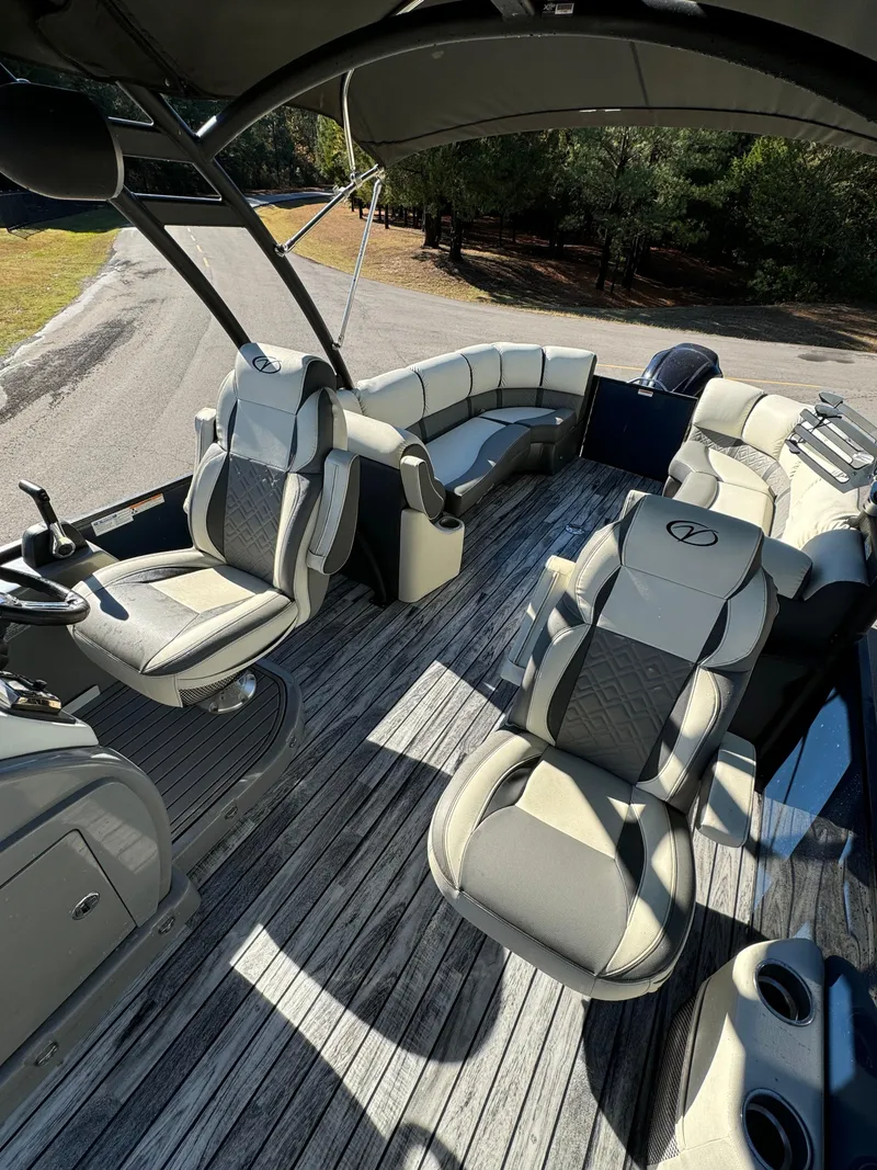 Slide: The Image of 2019 Veranda VP25RCT pontoon boat interior with luxurious seating and wood-style flooring. - 8