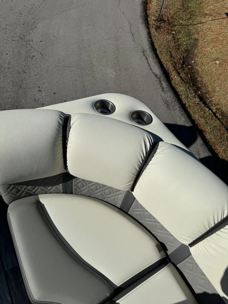 Slide: The Image of 2019 Veranda VP25RCT boat seating with cup holders on a sunny day. - 9