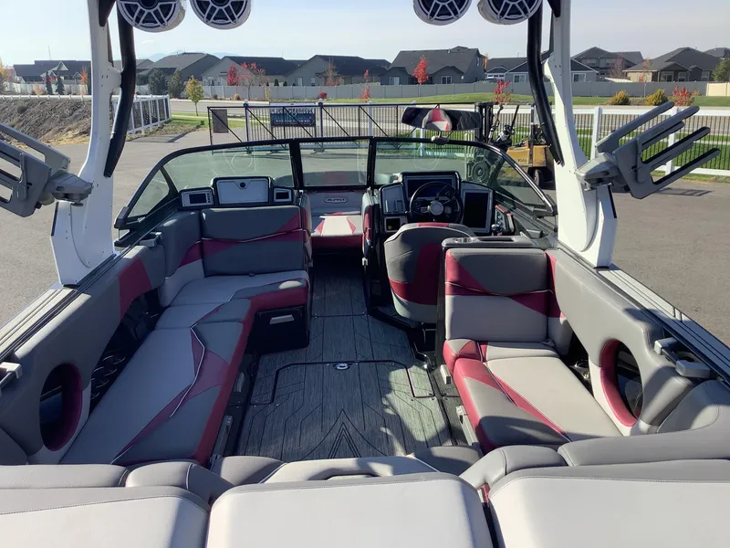 Slide: The Image of 2019 Supra SL450 boat interior with red and gray seating, advanced sound system. - 12