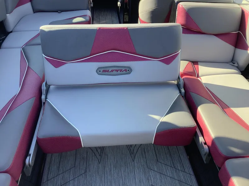 Slide: The Image of 2019 Supra SL450 boat interior with red and gray seating. - 27