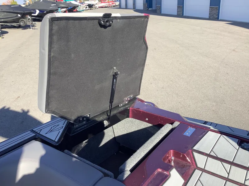 Slide: The Image of 2019 Supra SL450 boat storage compartment open in a sunny outdoor setting. - 28