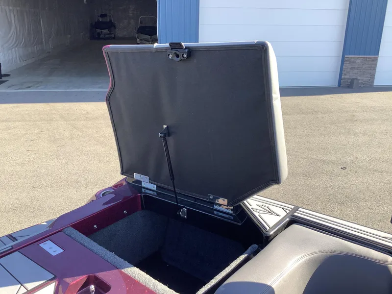 Slide: The Image of Open storage compartment of 2019 Supra SL450 boat in a sunny outdoor setting. - 29