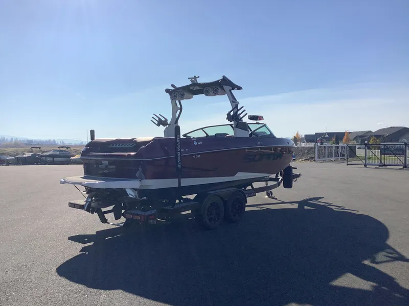 Slide: The Image of 2019 Supra SL450 boat on trailer in sunny outdoor setting. - 7
