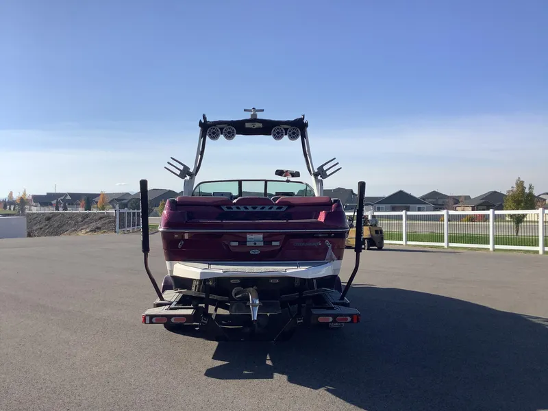 Slide: The Image of 2019 Supra SL450 boat parked on pavement under clear blue sky. - 8