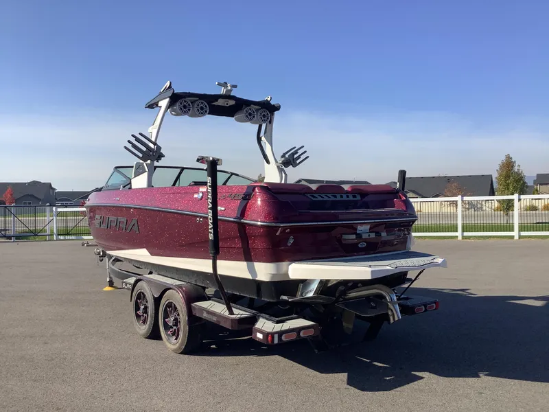Slide: The Image of 2019 Supra SL450 boat on trailer, parked outdoors under clear sky. - 9
