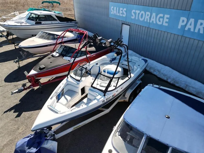 Slide: The Image of 2002 Tigé 22i boat in storage lot with other boats. - 14
