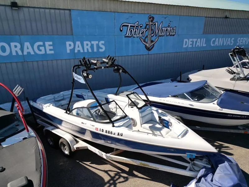 Slide: The Image of 2002 Tigé 22i boat at Tobler Marina, parked on a trailer. - 16