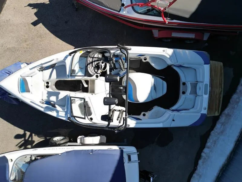Slide: The Image of Overhead view of a 2002 Tigé 22i boat, parked among other boats. - 17