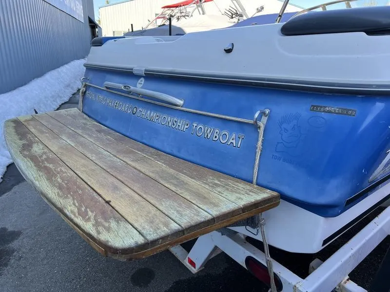 Slide: The Image of 2002 Tigé 22i boat rear view with wooden swim platform. - 20