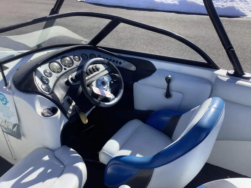 Slide: The Image of 2002 Tigé 22i boat interior with steering wheel and dashboard controls. - 24