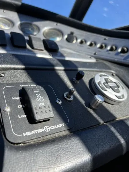 Slide: The Image of Control panel of a 2002 Tigé 22i boat with heater and switches. - 26