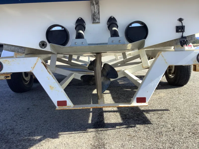 Slide: The Image of 2002 Tigé 22i boat on trailer, showing propeller and rear view. - 29