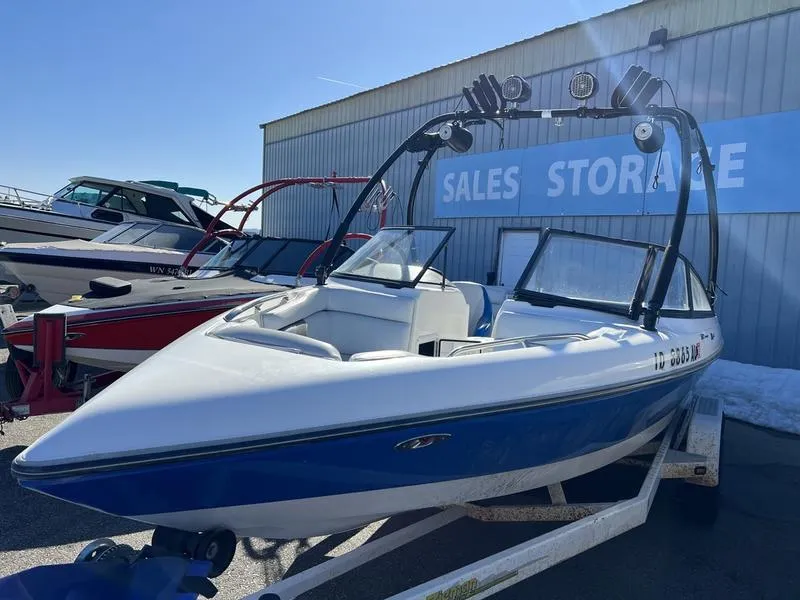 Slide: The Image of 2002 Tigé 22i boat on trailer, parked near sales storage facility. - 3