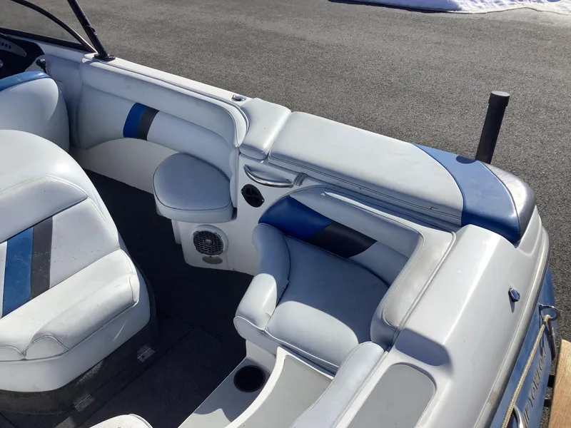 Slide: The Image of 2002 Tigé 22i boat interior with blue and gray seating. - 30