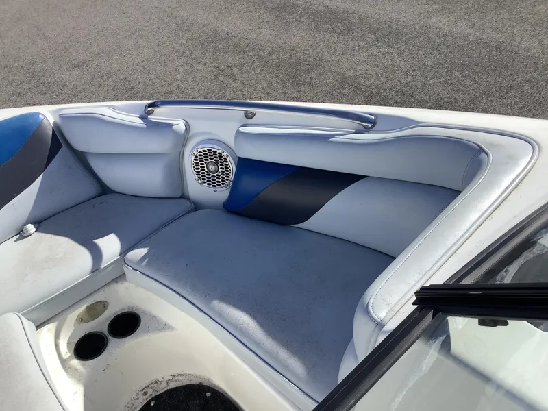 Slide: The Image of 2002 Tigé 22i boat interior with blue and gray seating and speaker. - 33