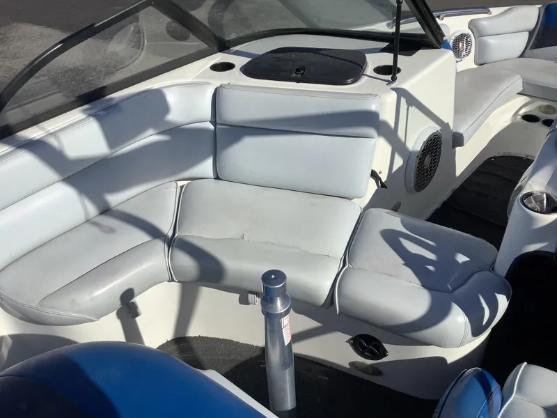 Slide: The Image of Interior of a 2002 Tigé 22i boat with white seating and speakers. - 35