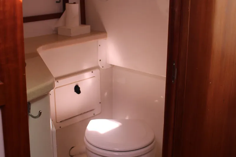 Slide: The Image of 2007 Back Cove 29 boat interior bathroom with toilet and storage cabinet. - 10