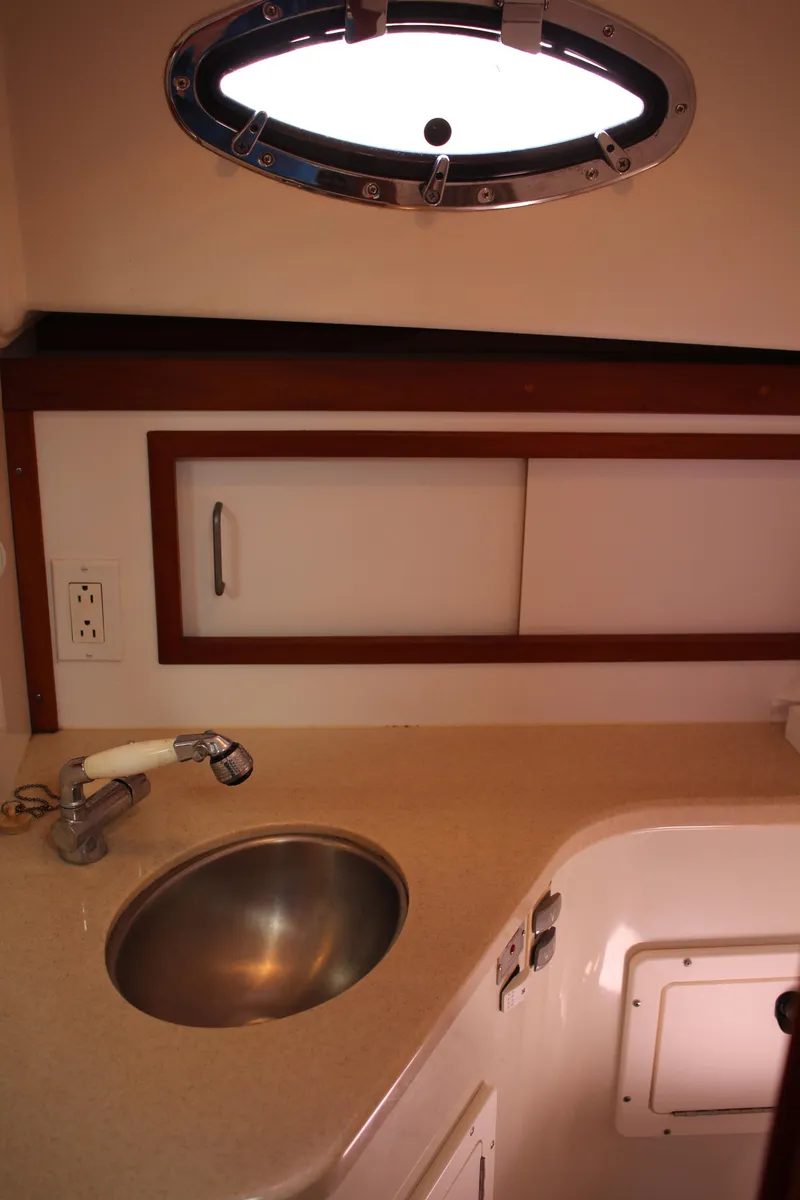 Slide: The Image of 2007 Back Cove 29 boat interior with sink and porthole window. - 11