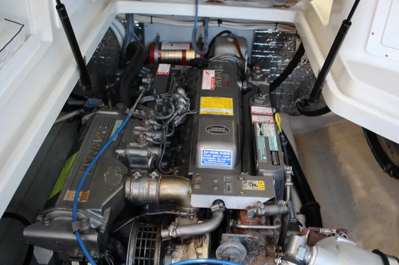 Slide: The Image of Engine compartment of a 2007 Back Cove 29 boat, showcasing detailed mechanical components. - 14